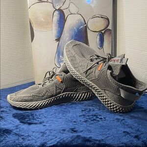 Gray Athletic Sneakers with Orange Accents, size 10 (pre-owned).